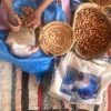 Women cracking Argan nuts in Arazane